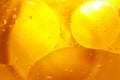 Gold Oil bubbles close up. circles of orange water macro. abstract shiny yellow background Royalty Free Stock Photo