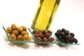 Gold olive oil in buttle with olives over white Royalty Free Stock Photo