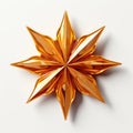 A gold origami star on a white surface