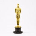 Gold Oscar statuette on a black base, isolated on a white Royalty Free Stock Photo