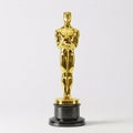 Gold Oscar statuette on a black base, isolated on a white Royalty Free Stock Photo
