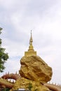 Gold pagoda on big yellow stone on white sky at wat phra phutthabat phra that In Kwaen in lamphun province of Thailand