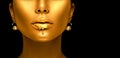 Gold paint drips from the lips, golden liquid drops on beautiful model girl`s mouth, creative abstract makeup Royalty Free Stock Photo