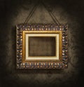 Gold picture frame on antique wallpaper