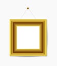 Gold picture frame hanging on white