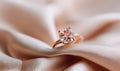 A gold and pink diamond ring is on a pink cloth Royalty Free Stock Photo