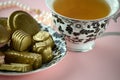 Luxurious gold French macarons and chocolates on a porcelain plate Royalty Free Stock Photo