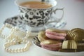 Luxurious gold French macarons and chocolates on a porcelain plate Royalty Free Stock Photo