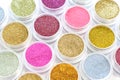 Gold and pink glitter in jars. Shiny powder, pigments, sparkle. Shimmer for manicure, makeup, nail art. Cosmetics. Royalty Free Stock Photo