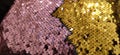 Gold, pink and multi-colored sparkles on the fabric. Rainbow blurred background. Shiny, sparkling in the sun, multi-colored Royalty Free Stock Photo