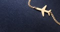Gold plane on a chain on a blue background