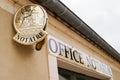 Gold plate sign Notaire logo in wall building office for french notary