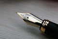 Gold plated fountain pen closeup on a wooden table Royalty Free Stock Photo