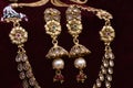 Gold plated Jewelry - Designer golden neck-set and earrings closeup macro image on red background