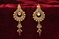 Gold plated jewelry - Fancy Designer golden pair of earrings closeup macro image