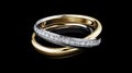 Gold and platinum diamond rings floating in three dimensions on a black background. The design represents a jewelry Royalty Free Stock Photo