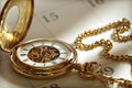 Gold pocket watch and calendar Royalty Free Stock Photo