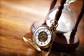 Gold pocket watch and hourglass Royalty Free Stock Photo