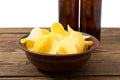 Gold potato chips on grey plate on wood table isolated on white background Royalty Free Stock Photo