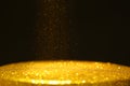 Gold powder with glitter lights on black background with copy space Royalty Free Stock Photo