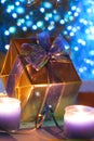 Gold present lit by candles Royalty Free Stock Photo