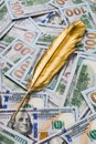 Gold quill pen on dollar money background