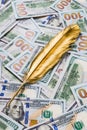 Gold quill pen on dollar money background