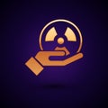 Gold Radioactive in hand icon isolated on black background. Radioactive toxic symbol. Radiation Hazard sign. Vector.