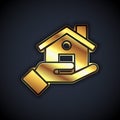 Gold Realtor icon isolated on black background. Buying house. Vector