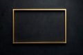 Gold rectangular frame against a dark textured background ready for artwork display or decoration Royalty Free Stock Photo
