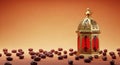A gold and red lantern surrounded by dates on a brown surface Royalty Free Stock Photo