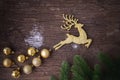 Gold Reindeer with bauble on wooden table, Christmas decorations background Royalty Free Stock Photo