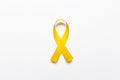 Gold ribbon as symbol of childhood cancer awareness isolated on
