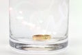 A gold ring in a glass of water. Royalty Free Stock Photo