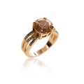 the gold ring with a smoky quartz stone Isolated on white. Big champagne diamond. DOG. Macro lens. Macro blurred. Royalty Free Stock Photo