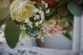 gold rings and a beautiful bridal bouquet of roses on the background. details  wedding traditions. close-up  macro Royalty Free Stock Photo