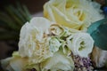 gold rings and a beautiful bridal bouquet of roses on the background. details  wedding traditions. close-up  macro Royalty Free Stock Photo