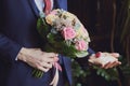 gold rings and a beautiful bridal bouquet of roses on the background. details  wedding traditions. close-up  macro Royalty Free Stock Photo