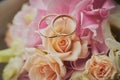 gold rings and a beautiful bridal bouquet of roses on the background. details  wedding traditions. close-up  macro Royalty Free Stock Photo