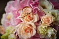 gold rings and a beautiful bridal bouquet of roses on the background. details  wedding traditions. close-up  macro Royalty Free Stock Photo