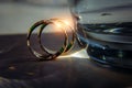 Gold rings of the newlyweds shine and reflect the light, close-up, blurred background. Abstract photo, wedding accessories