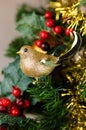 Gold robin and holly Christmas decorations. Royalty Free Stock Photo