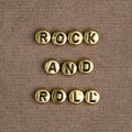 Gold ROCK AND ROLL beads word typography Royalty Free Stock Photo