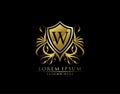 Gold Royal Shield W Letter Logo. Graceful Elegant gold shield icon design