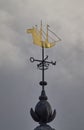 The unique gold covered weather vane in a shape of a sailing ship on the roof of the Dutch Naval Academy in Den Helder. Royalty Free Stock Photo