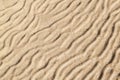 Gold sand with abstract wave pattern. Sand texture background. Summer and holiday concept. Royalty Free Stock Photo