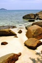 Gold sand beach with stone rocks