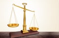 Gold scales of justice on brown background Royalty Free Stock Photo