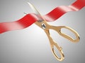 Gold scissors cutting a red tape ribbon