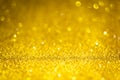 Gold shiny glitter texture. Selective focus. Glowing surface, sparkle lights and bokeh effects. Christmas and festive Royalty Free Stock Photo